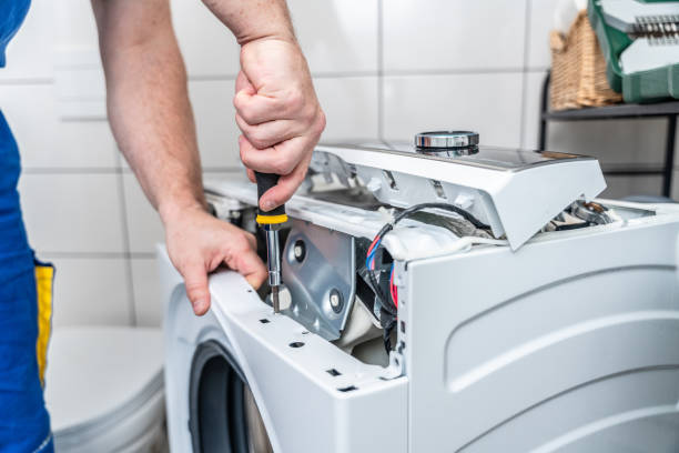 Electrician inspecting a faulty appliance in a Townsville home