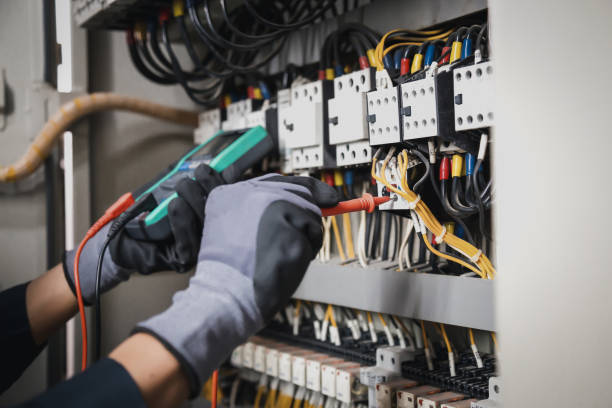 Electrician upgrading an old switchboard in a Townsville home