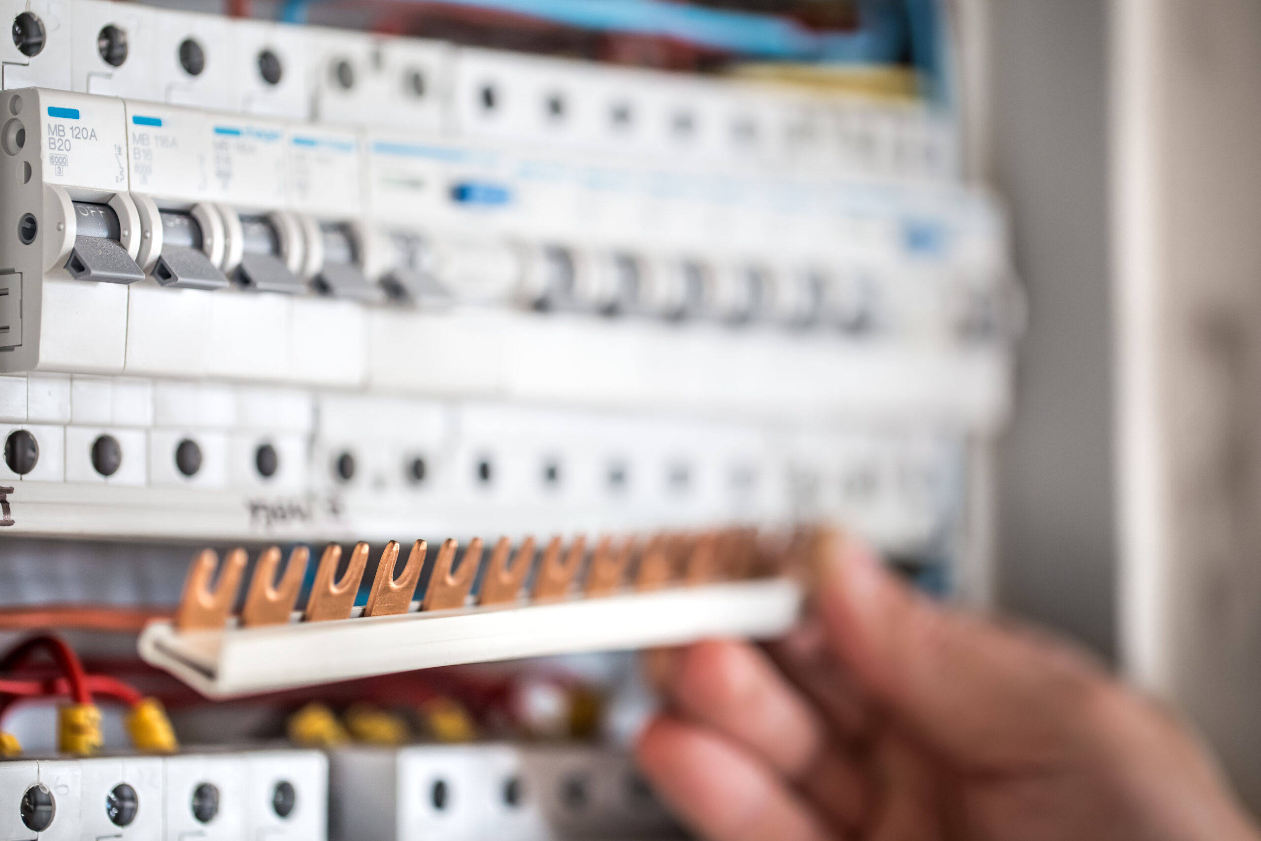 Electrician working on a switchboard with fuses in a Townsville home